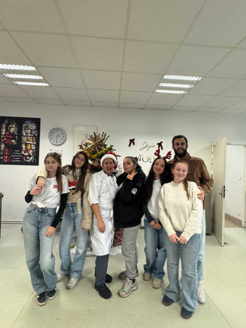 les jeunes, dans une ambiance festive et de Noel, sont à la cantine du Campus Saint-Antoine. Ils encouragent les personnes qui trient leurs déchets.