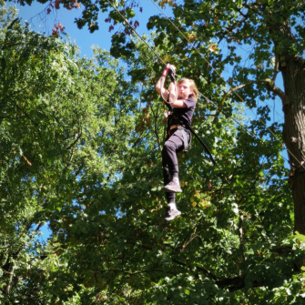un élève fait de l'accrobranche