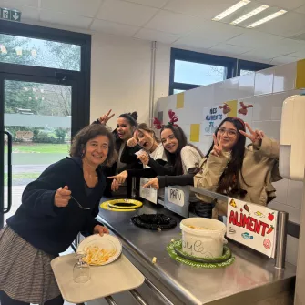 les jeunes, dans une ambiance festive et de Noel, sont à la cantine du Campus Saint-Antoine. Ils encouragent les personnes qui trient leurs déchets.