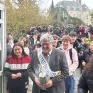 Denis Dugord entre dans le forum accompagné des jeunes. il porte une écharpe "mister retraite"